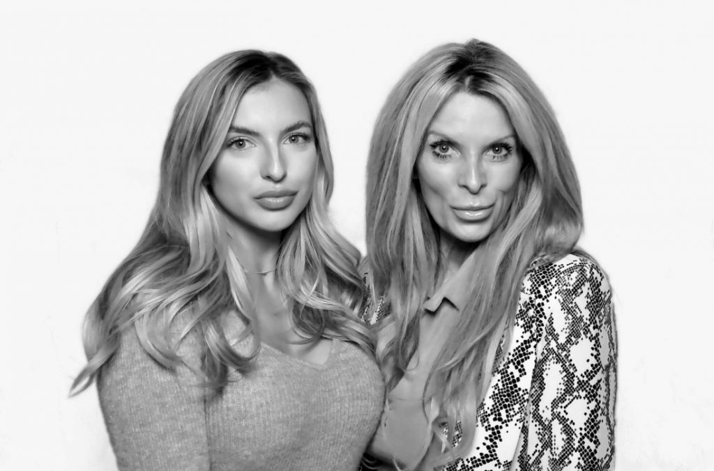 two ladies posing for black and white photo booth