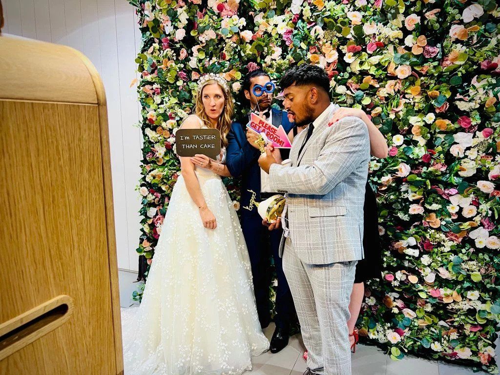 couple posing for their wedding photo booth